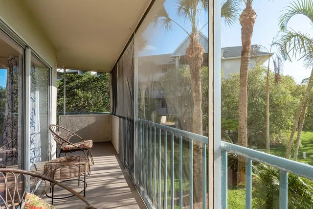 a balcony with view of swimming pool