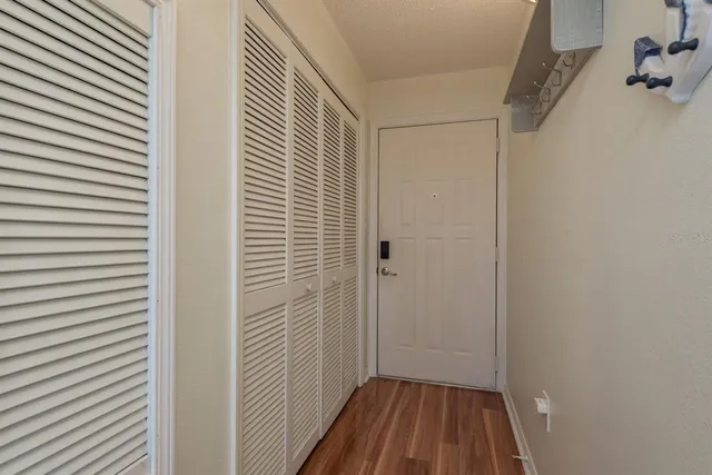 a view of a room with wooden floor