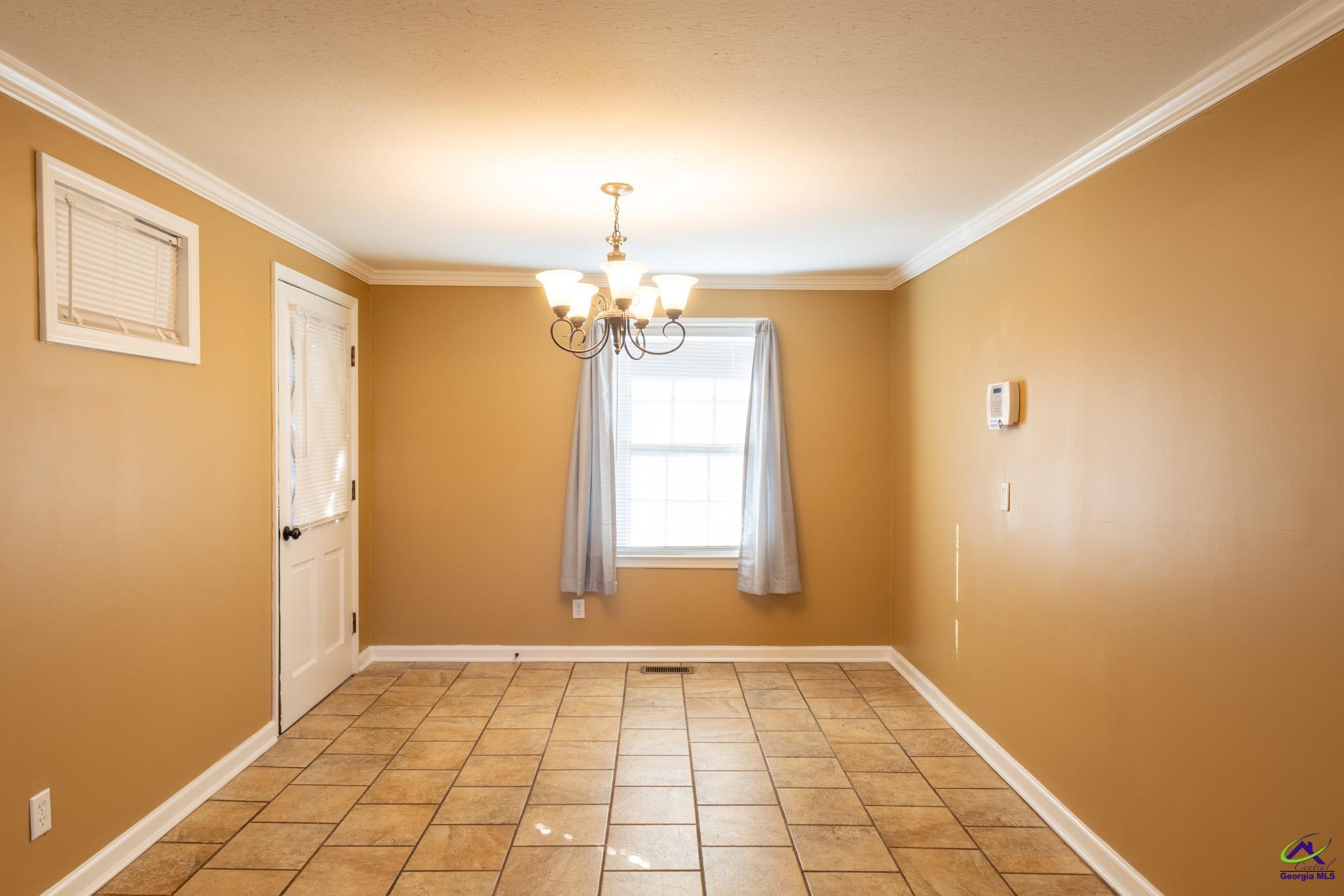 3491 Sandy Circle Macon, GA 31216 - Photo 11 of 47 a view of a room with window and chandelier fan