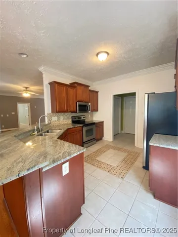 a kitchen with granite countertop a stove and a sink