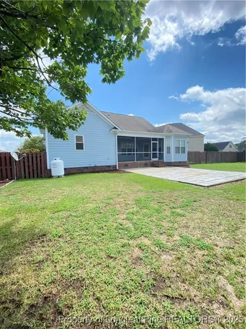 a view of a house with a yard and sitting area
