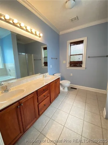 a spacious bathroom with a double vanity sink and a mirror