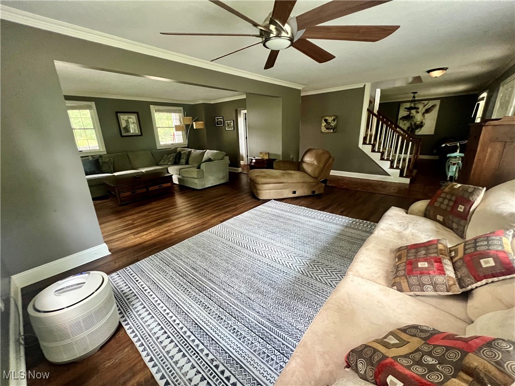3840 Tabor Ridge Road Northeast Mineral City, OH 44656 - Photo 18 of 40 Living room featuring crown molding, hardwood / wood-style floors, and ceiling fan