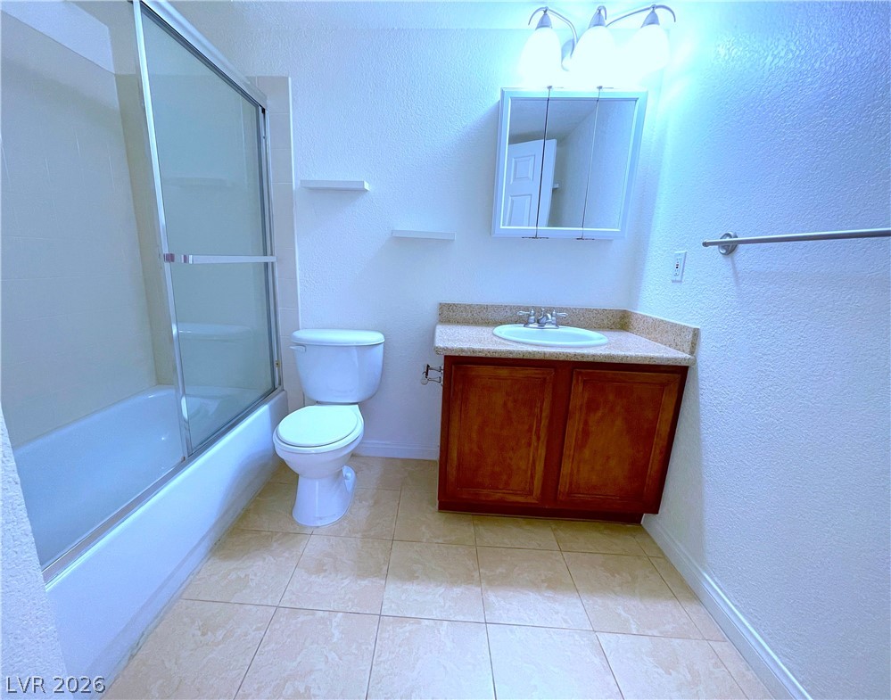 3135 South Mojave Road, Unit 156 Las Vegas, NV 89121 - Photo 9 of 18 A compact bathroom featuring a full bathtub with shower, a vanity, and a toilet.