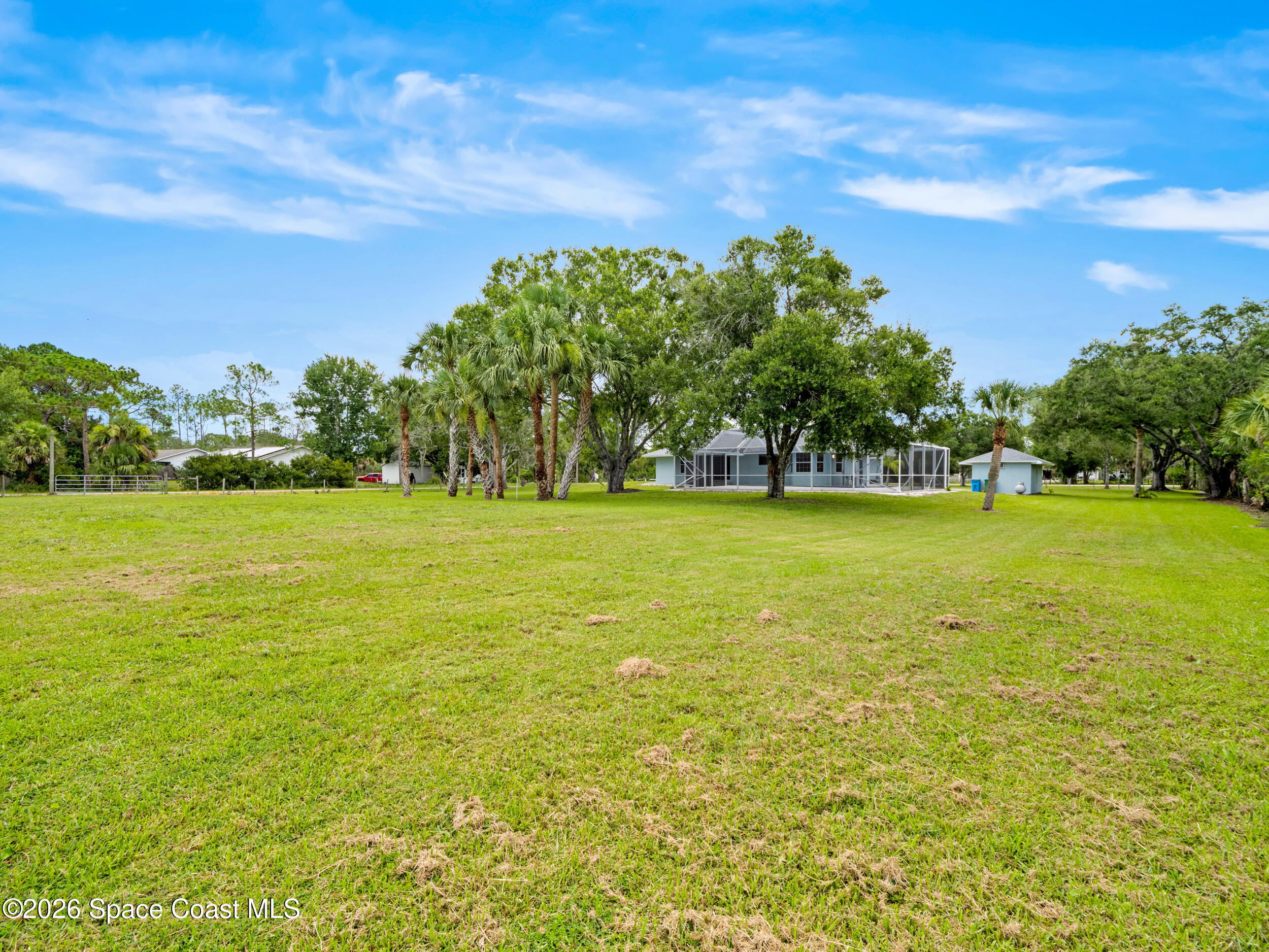 3480 Weber Road Malabar, FL 32950 - Photo 30 of 45 a view of a large yard with swimming pool and green space