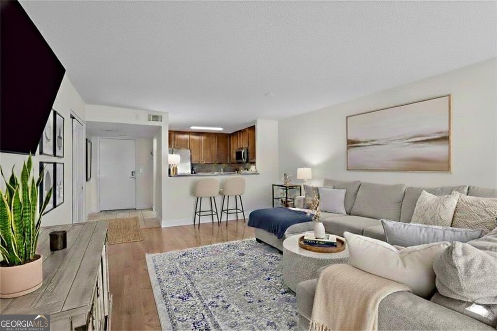 a living room with furniture and wooden floor