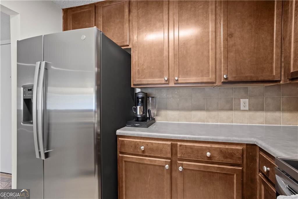 3650 Ashford Dunwoody Road Northeast, Unit 515 Atlanta, GA 30319 - Photo 7 of 14 a kitchen with metallic refrigerator and cabinets