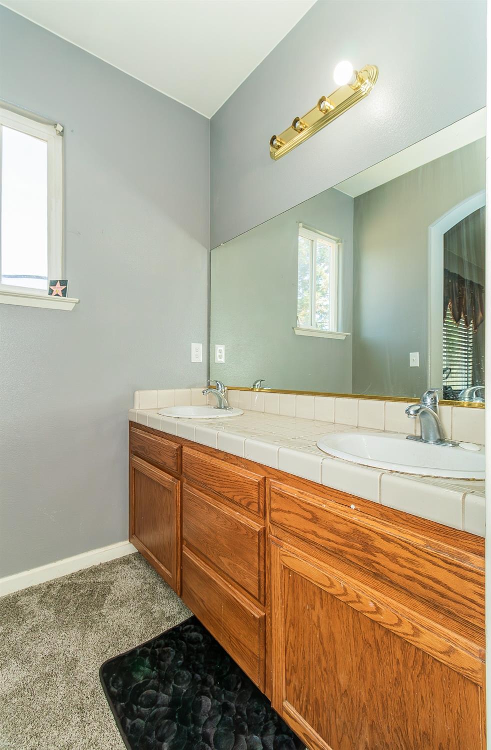 2666 Tammy Street Selma, CA 93662 - Photo 12 of 22 a bathroom with a sink and a mirror