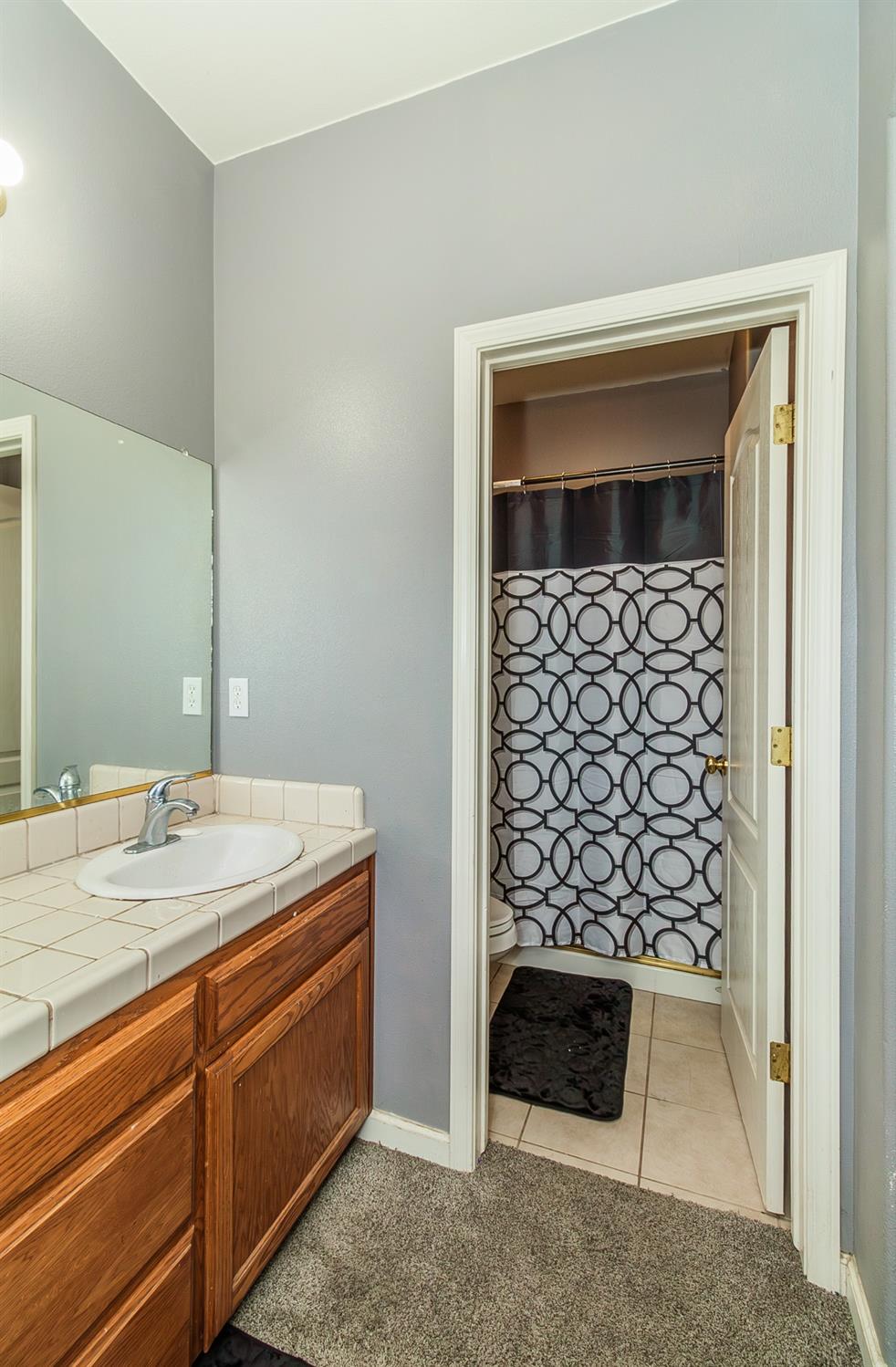 2666 Tammy Street Selma, CA 93662 - Photo 13 of 22 a bathroom with a sink a vanity and a shower