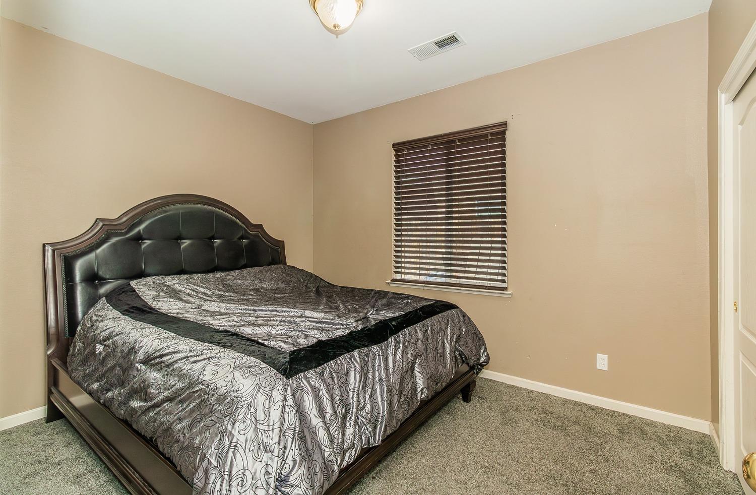 2666 Tammy Street Selma, CA 93662 - Photo 14 of 22 a bedroom with a bed and a window