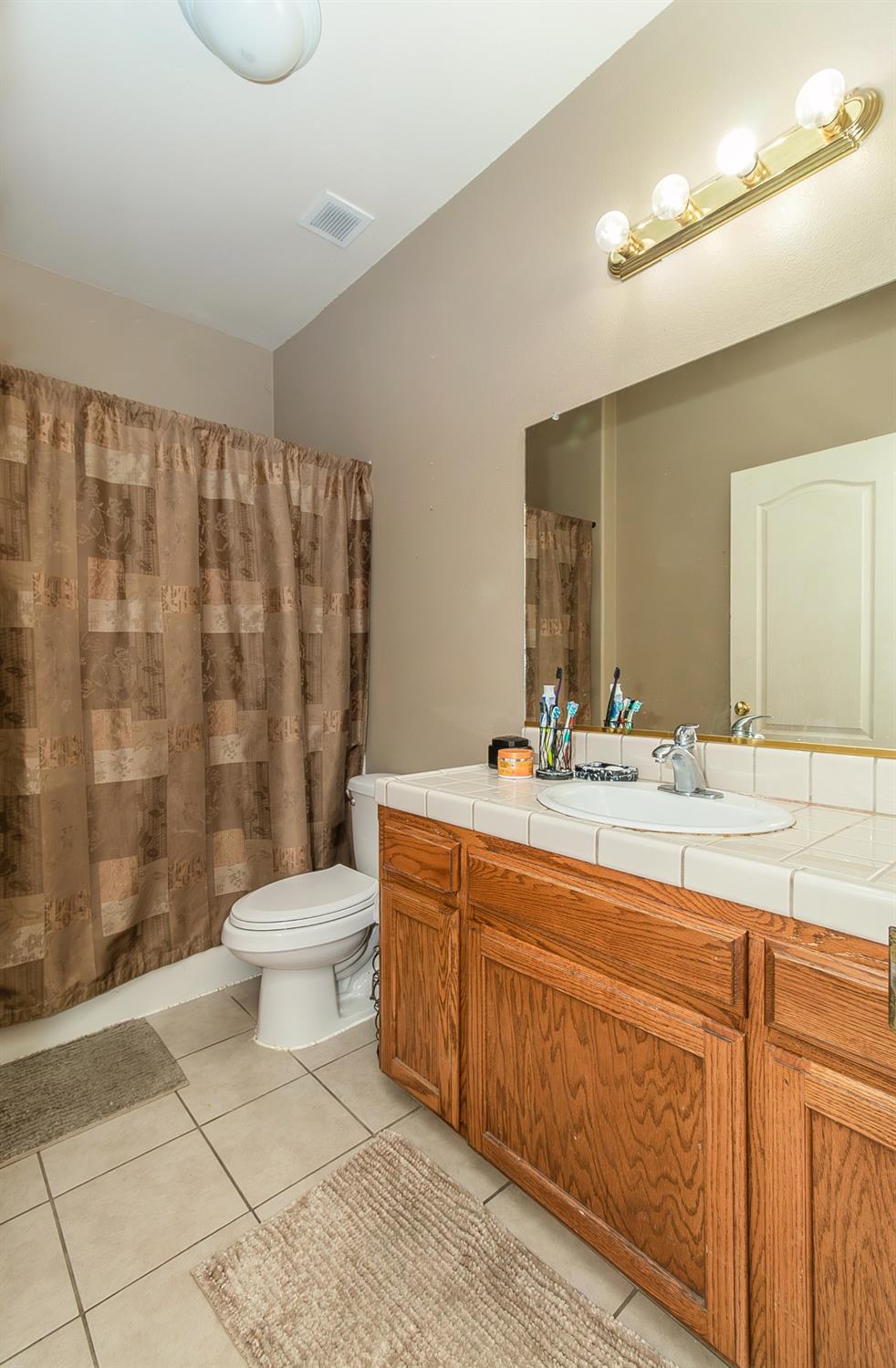 2666 Tammy Street Selma, CA 93662 - Photo 15 of 22 a bathroom with a sink a toilet and shower