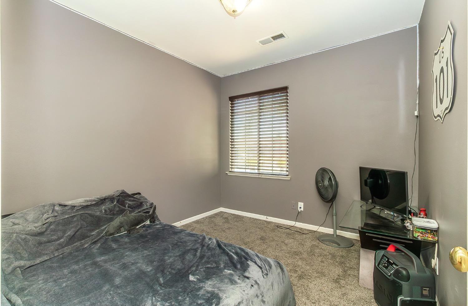 2666 Tammy Street Selma, CA 93662 - Photo 16 of 22 a bedroom with a bed and a window