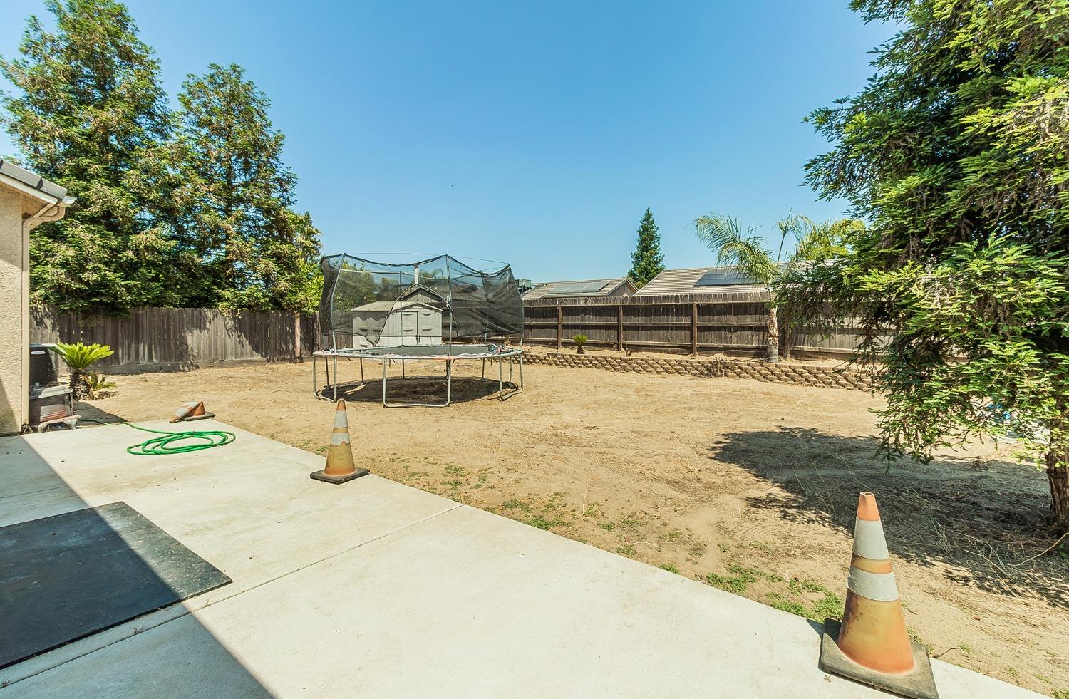 2666 Tammy Street Selma, CA 93662 - Photo 18 of 22 a view of a swimming pool with a yard