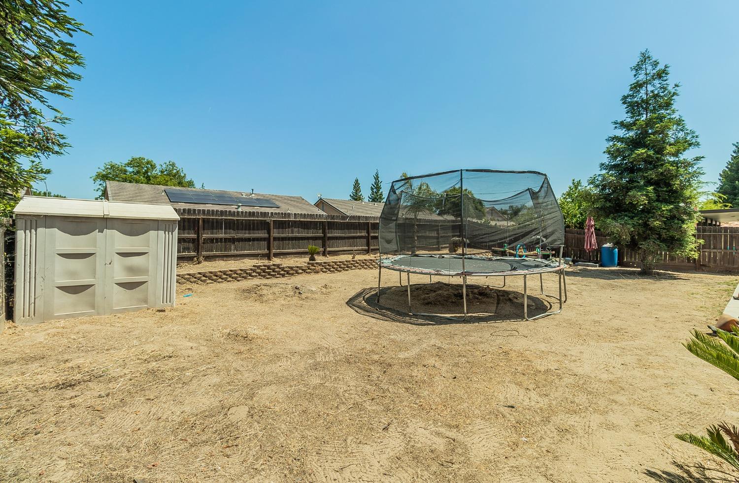 2666 Tammy Street Selma, CA 93662 - Photo 20 of 22 a view of a swimming pool with a yard