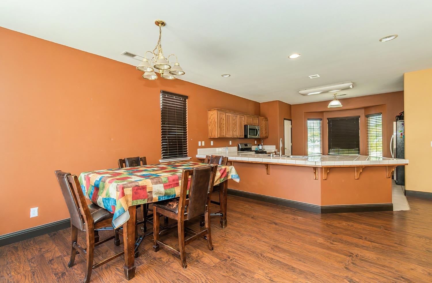 2666 Tammy Street Selma, CA 93662 - Photo 7 of 22 a dining room with furniture a chandelier and wooden floor