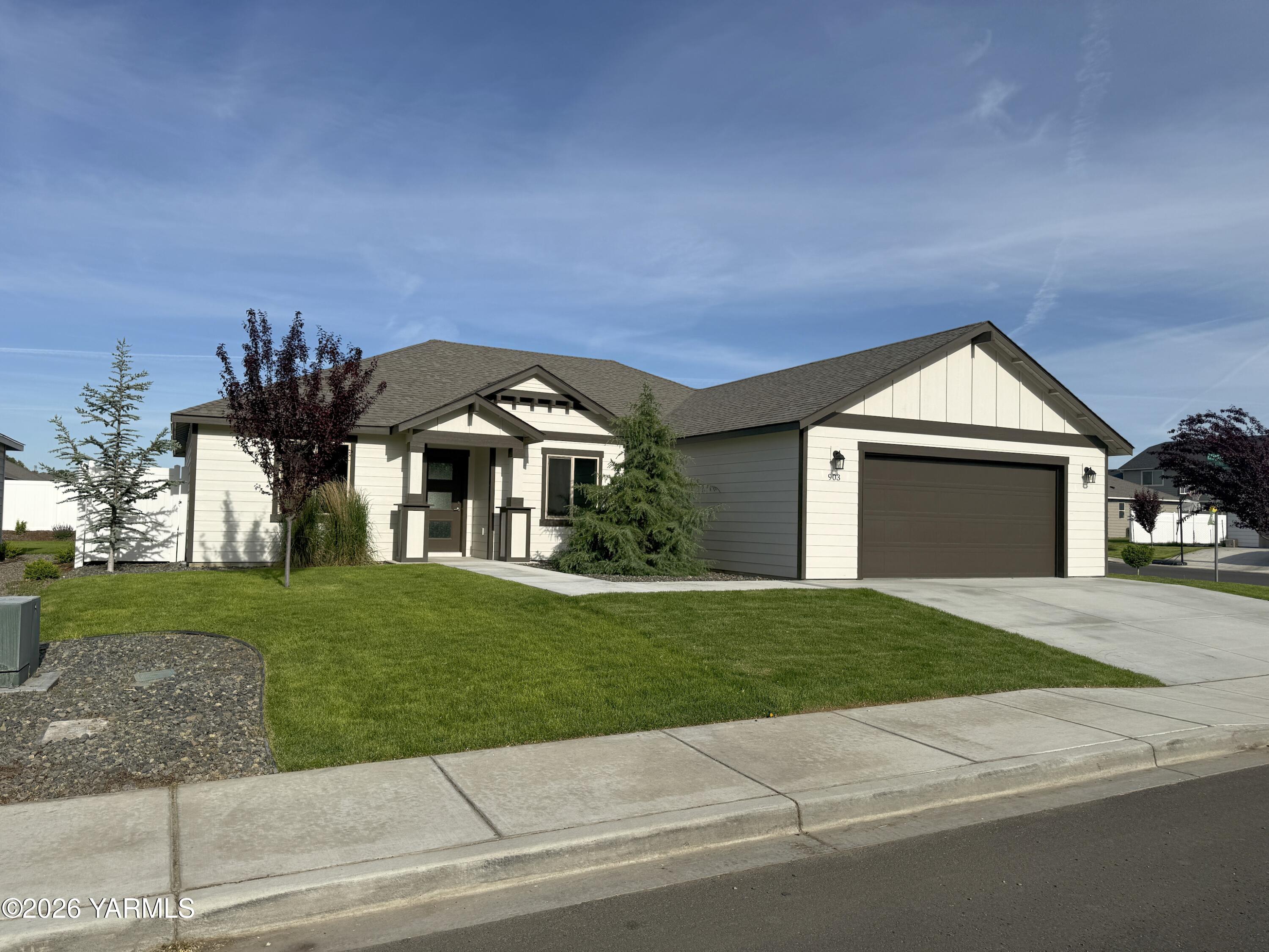 903 North Euclid Road, Unit PHASE 1 LOT 8) SPEC Grandview, WA 98930 - Photo 1 of 25 a front view of a house with a yard and garage