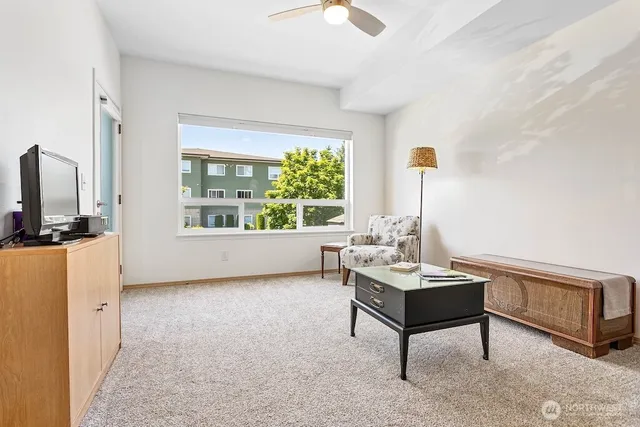 a living room with furniture and a large window