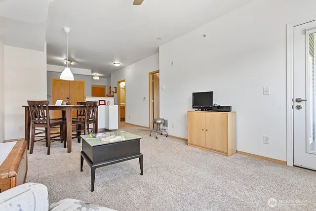 a living room with furniture and kitchen view