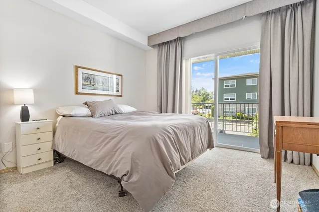 a bedroom with a bed and a large window