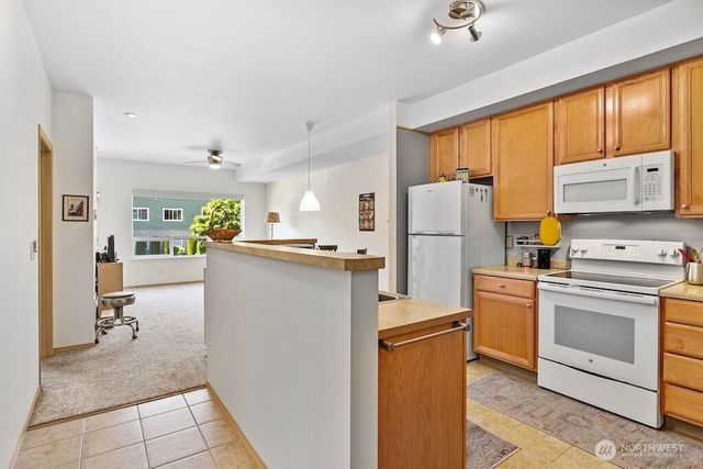a kitchen with refrigerator cabinets and large window