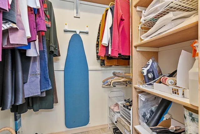 a view of walk in closet with clothes