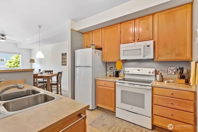 a kitchen with a stove a refrigerator and a sink