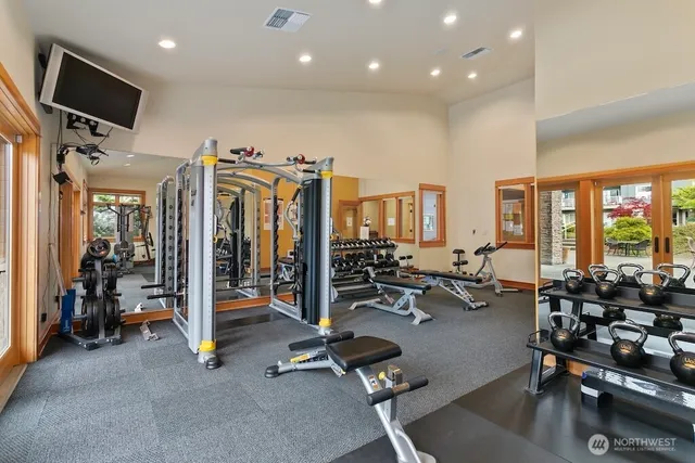a view of a room with gym equipment and a large window