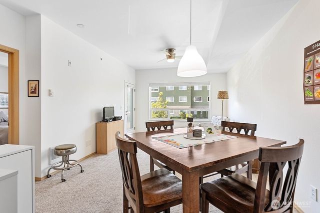 a view of a dining room with a table and chairs