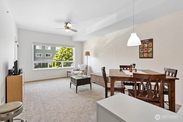 a living room with lots of furniture and a large window