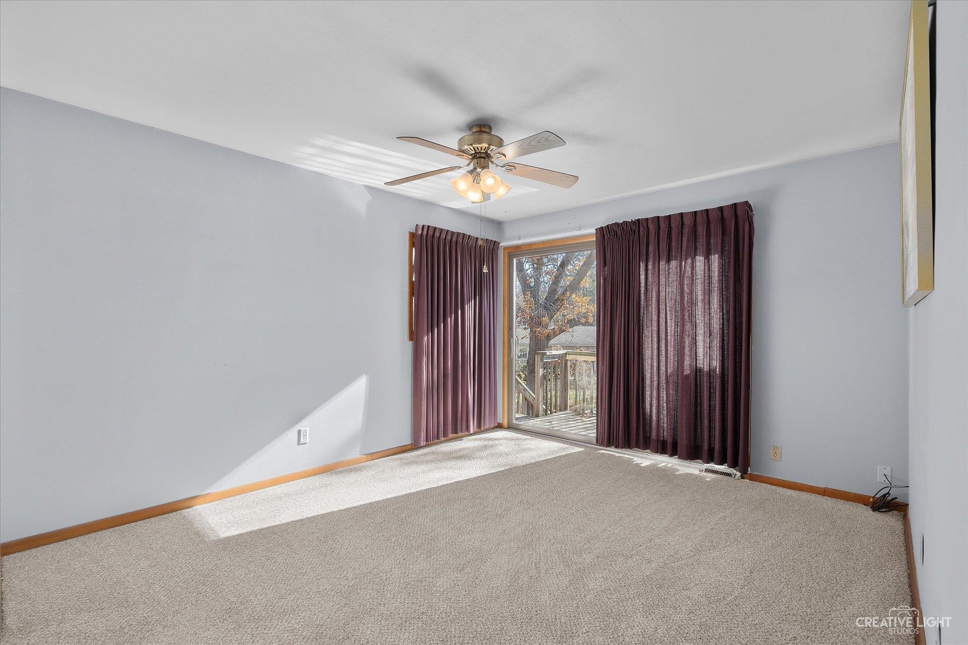 7927 Walnut Street Dixon, IL 61021 - Photo 11 of 33 a view of a livingroom with a ceiling fan and window