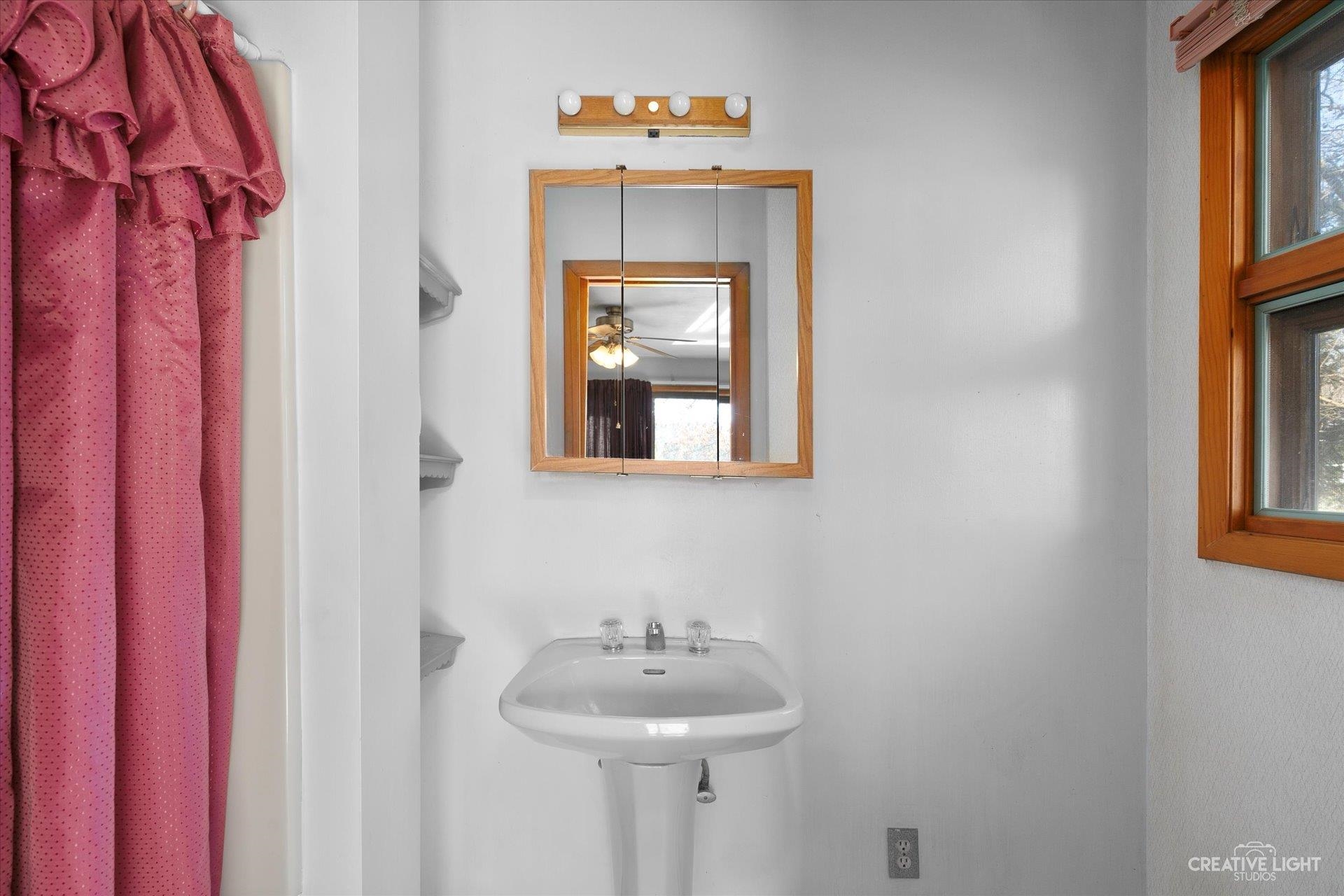 7927 Walnut Street Dixon, IL 61021 - Photo 12 of 33 a bathroom with a sink and a mirror