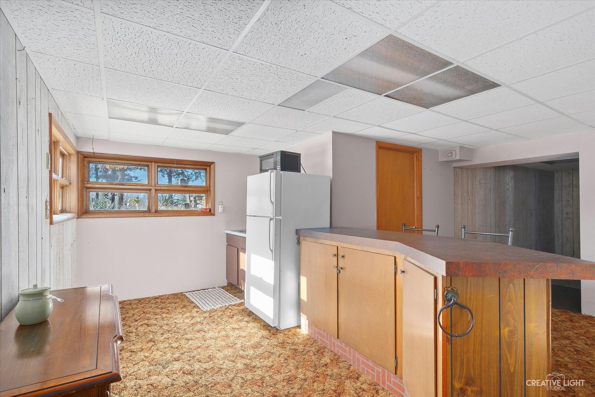 7927 Walnut Street Dixon, IL 61021 - Photo 17 of 33 a kitchen with stainless steel appliances granite countertop a refrigerator a stove and a sink with wooden floor
