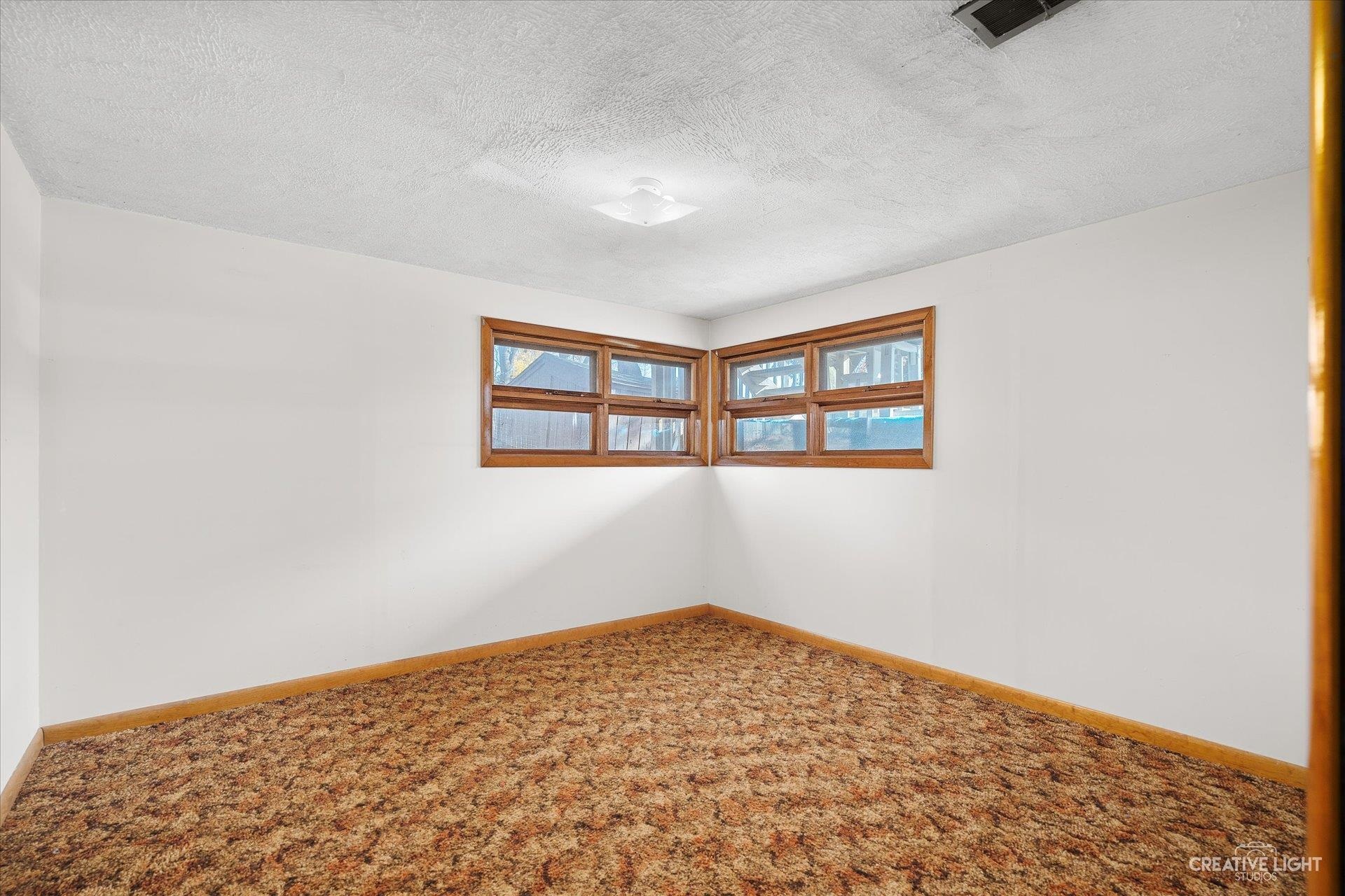 7927 Walnut Street Dixon, IL 61021 - Photo 18 of 33 a view of a big room with wooden floor and windows