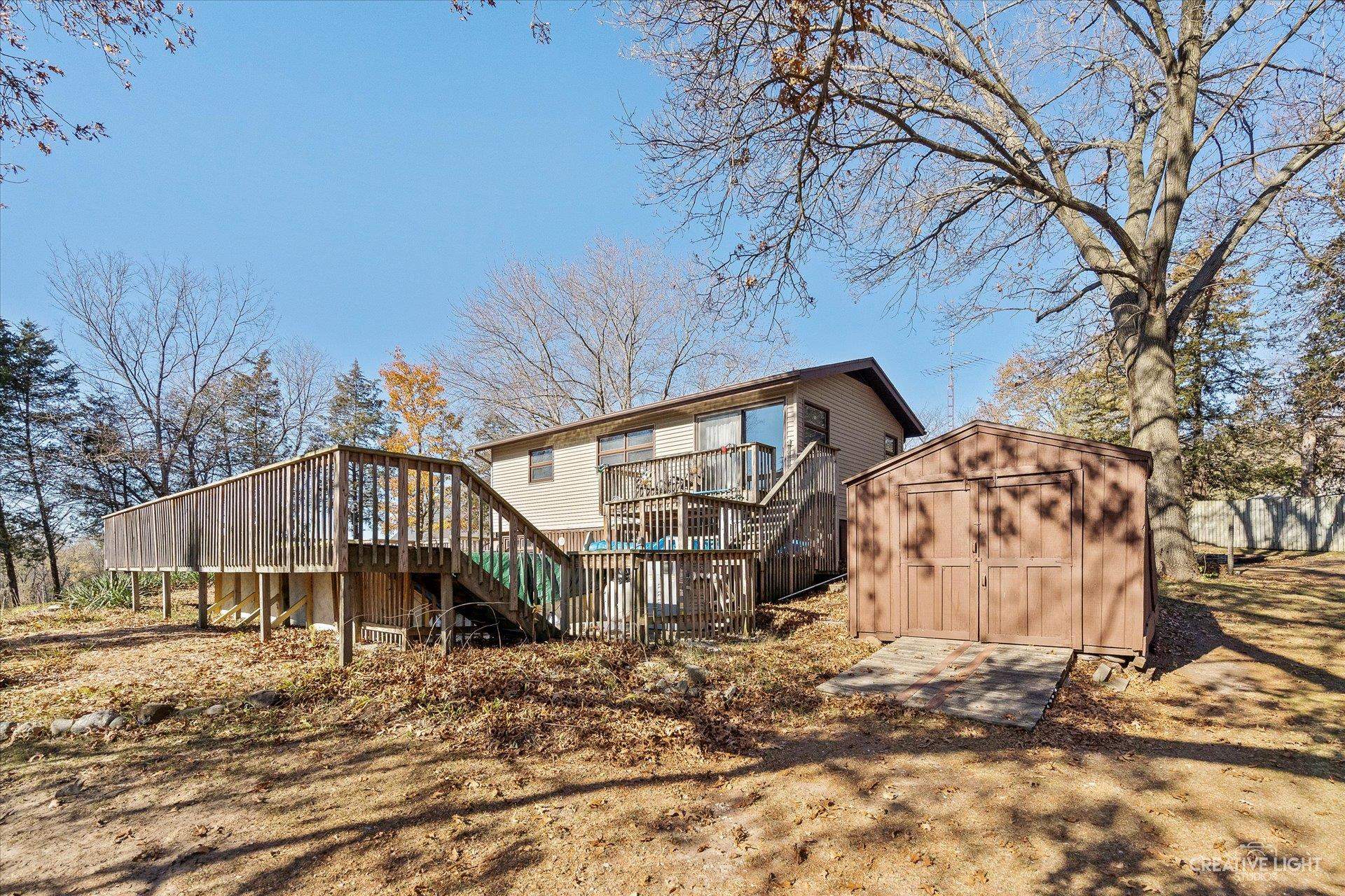 7927 Walnut Street Dixon, IL 61021 - Photo 23 of 33 a backyard of a house with large trees and wooden fence