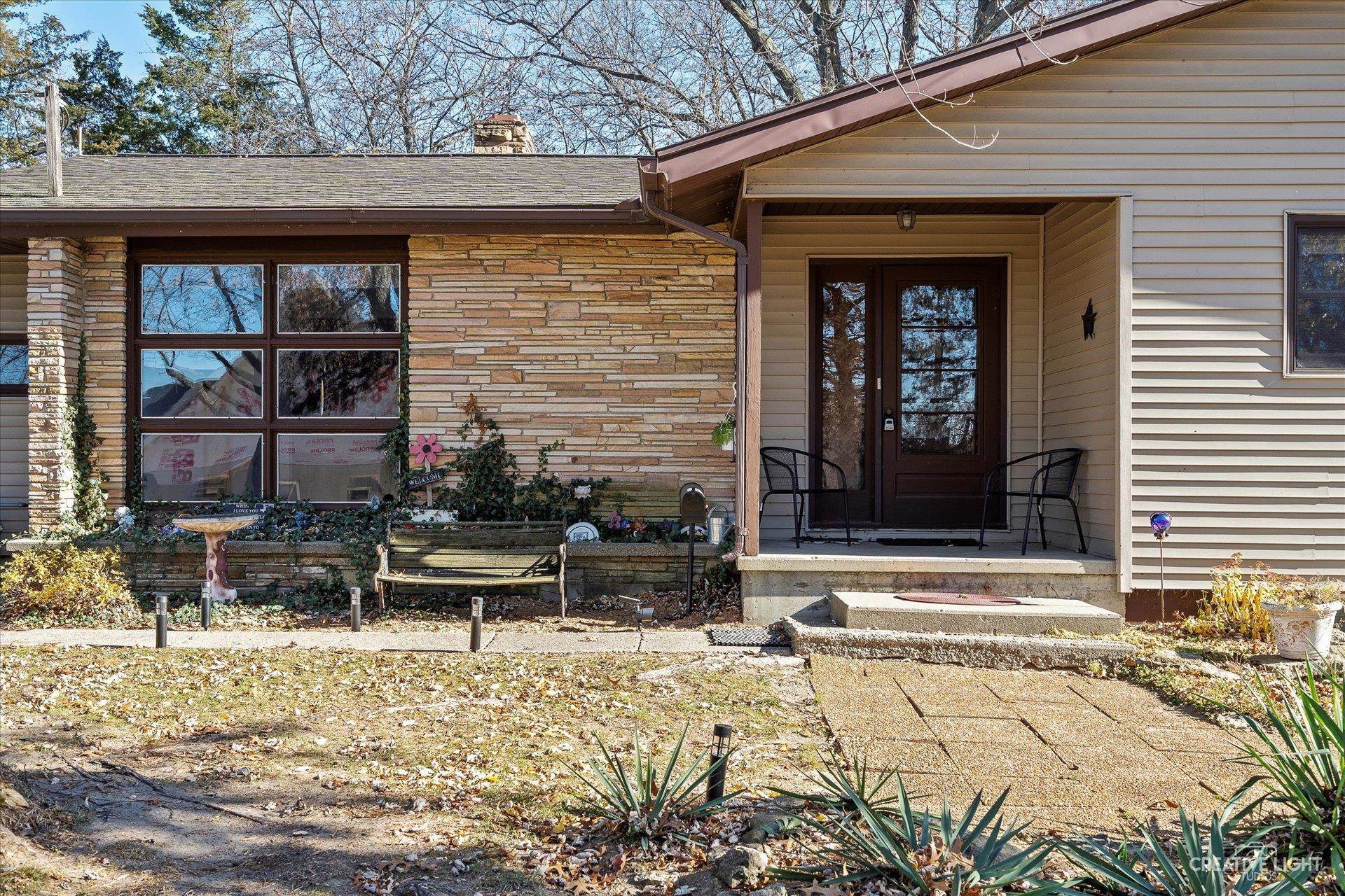 7927 Walnut Street Dixon, IL 61021 - Photo 3 of 33 a front view of a house with garden