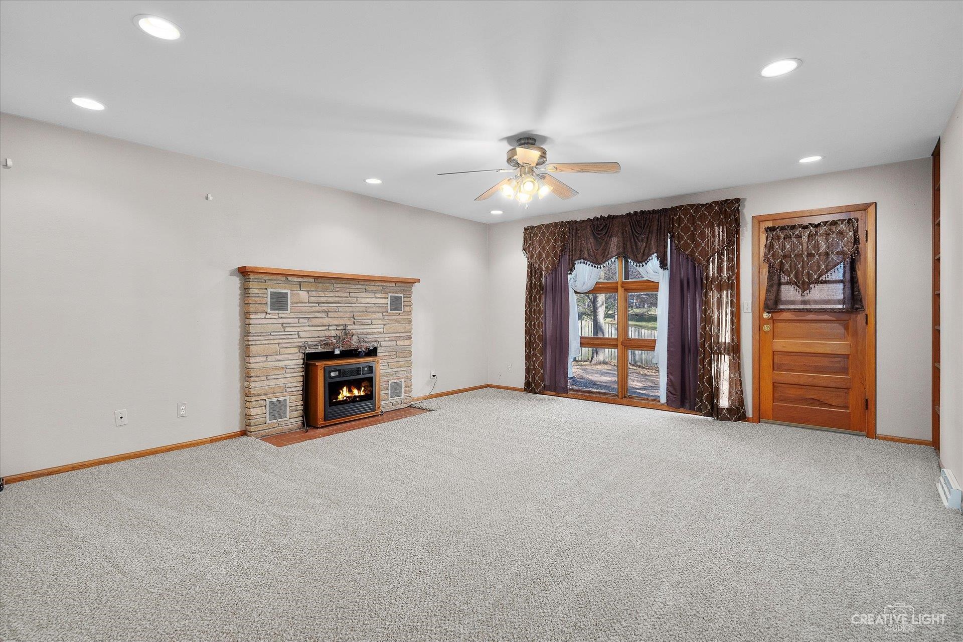 7927 Walnut Street Dixon, IL 61021 - Photo 4 of 33 an empty room with furniture and a fireplace