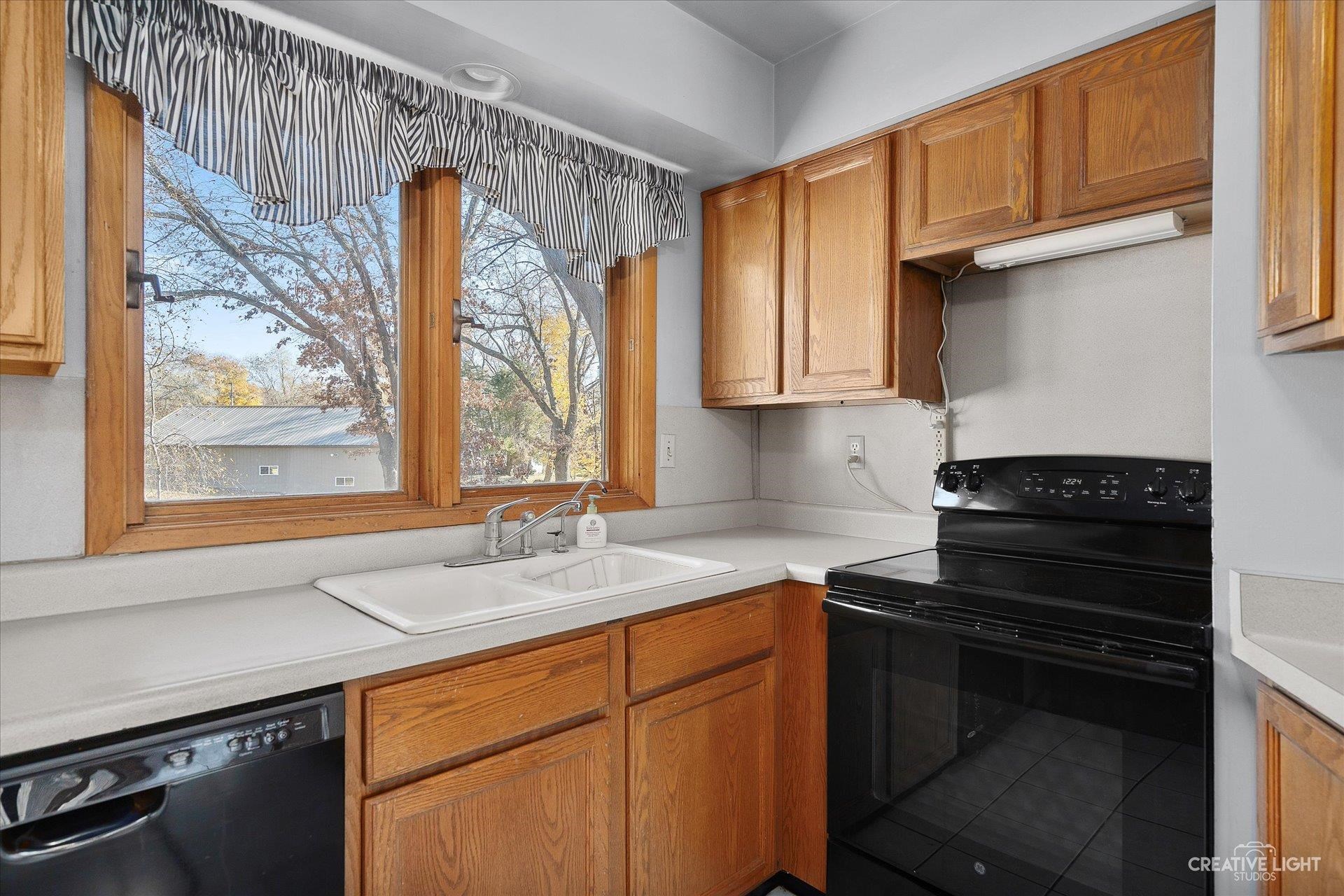7927 Walnut Street Dixon, IL 61021 - Photo 9 of 33 a kitchen with a sink stove and cabinets