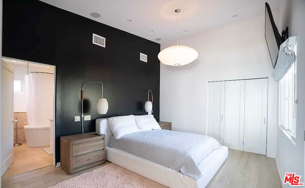 24742 Malibu Road Malibu, CA 90265 - Photo 15 of 18 a bedroom with a bed and a night stand