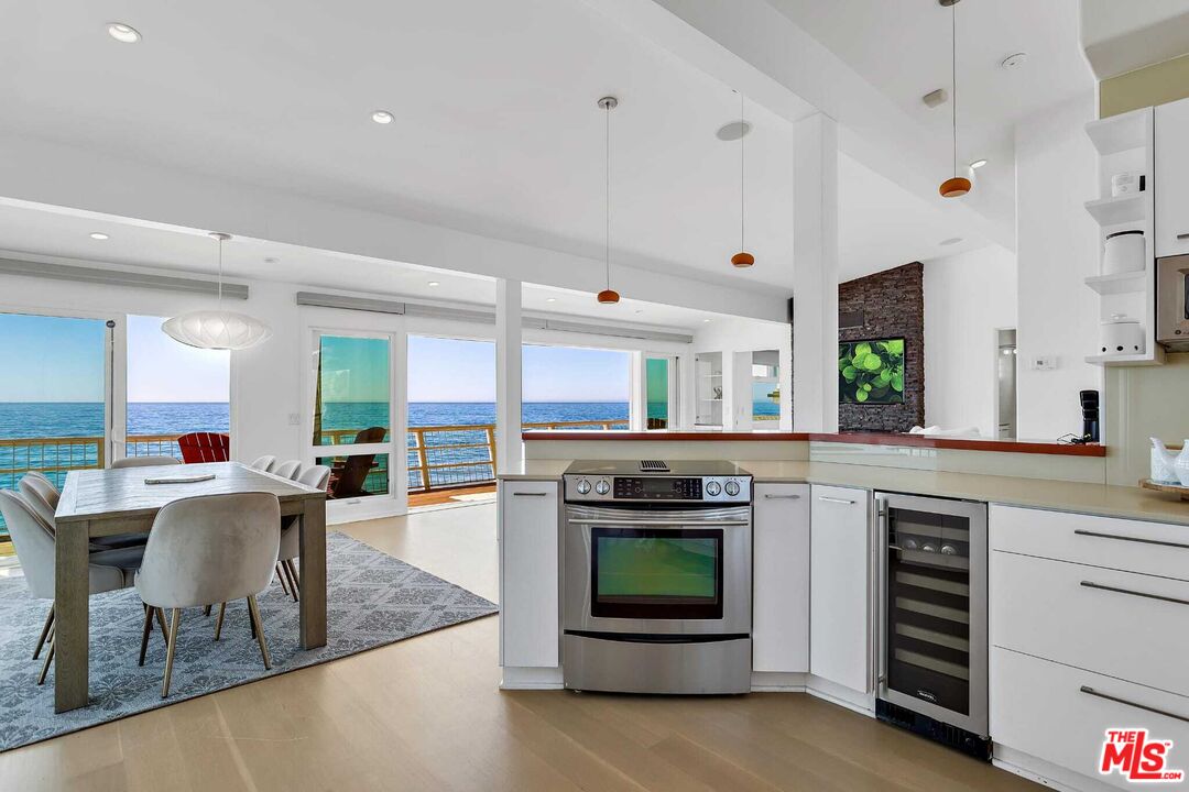 24742 Malibu Road Malibu, CA 90265 - Photo 10 of 18 a kitchen with microwave a stove and cabinets
