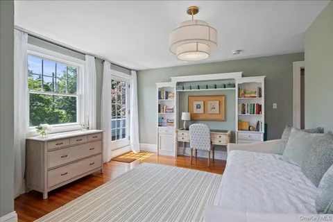 a bedroom with furniture and a window