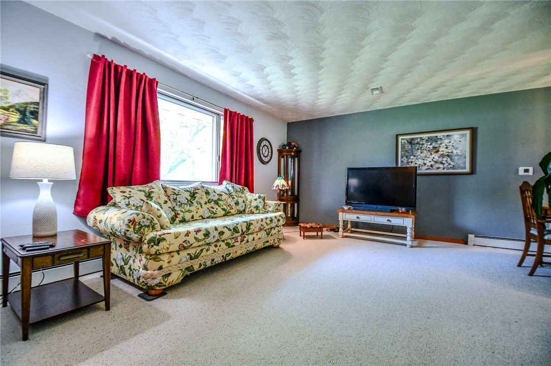 10833 Kendig Road Medway, OH 45341 - Photo 11 of 46 This inviting living room offers comfort and a tranquil atmosphere for daily living.