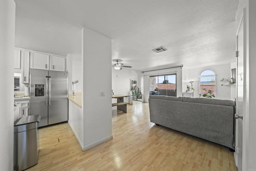 10775 Tamar Terrace, Unit A Santee, CA 92071 - Photo 1 of 38 a living room with furniture and kitchen view