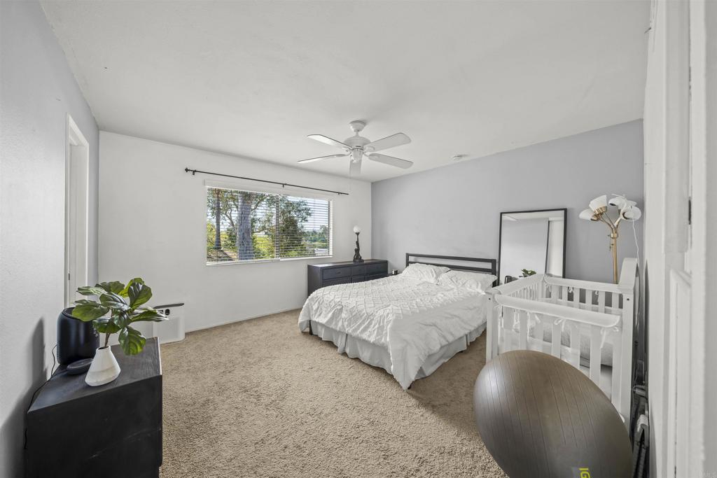 10775 Tamar Terrace, Unit A Santee, CA 92071 - Photo 11 of 38 a bedroom with a bed and a potted plant