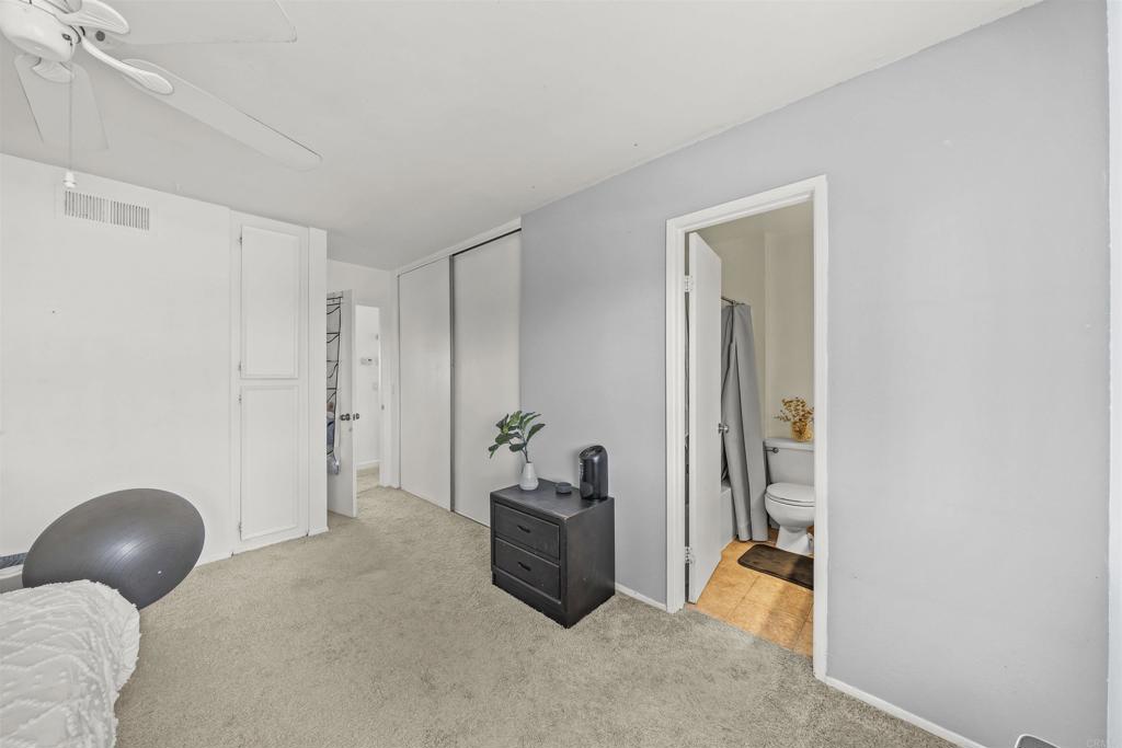 10775 Tamar Terrace, Unit A Santee, CA 92071 - Photo 12 of 38 a bedroom with a bed and a chandelier