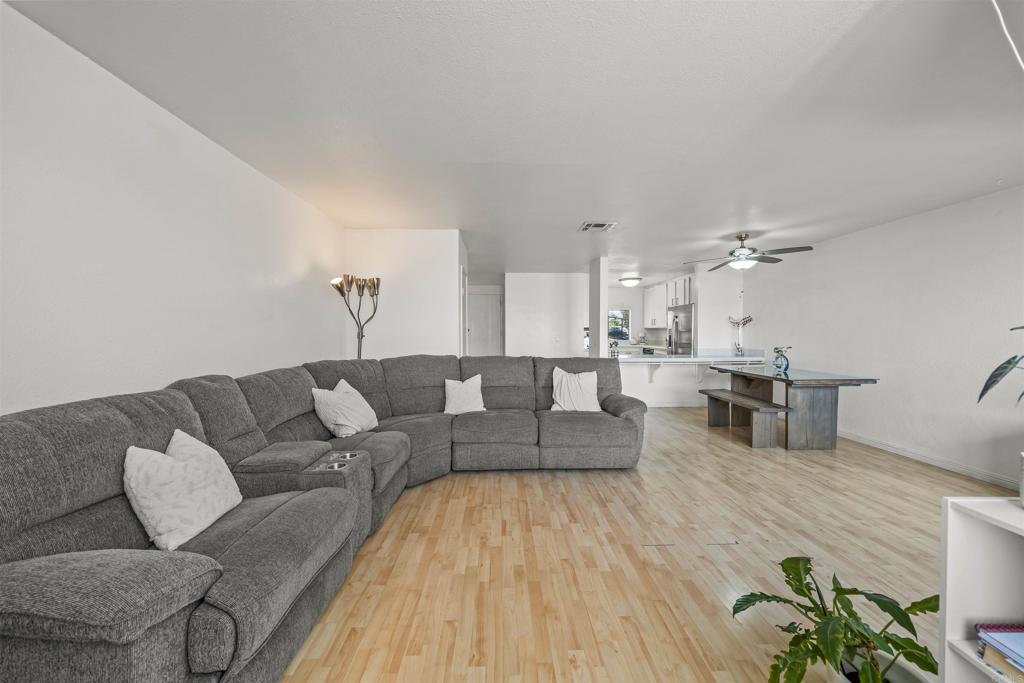10775 Tamar Terrace, Unit A Santee, CA 92071 - Photo 2 of 38 a living room with furniture and a wooden floor
