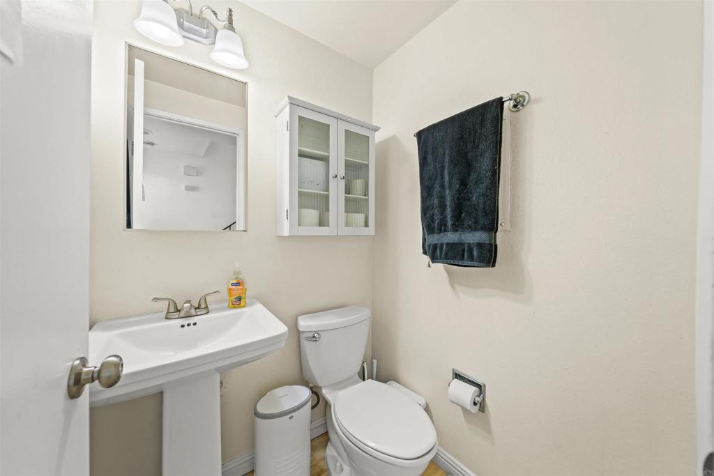 10775 Tamar Terrace, Unit A Santee, CA 92071 - Photo 30 of 38 a white toilet sitting next to a bathroom sink