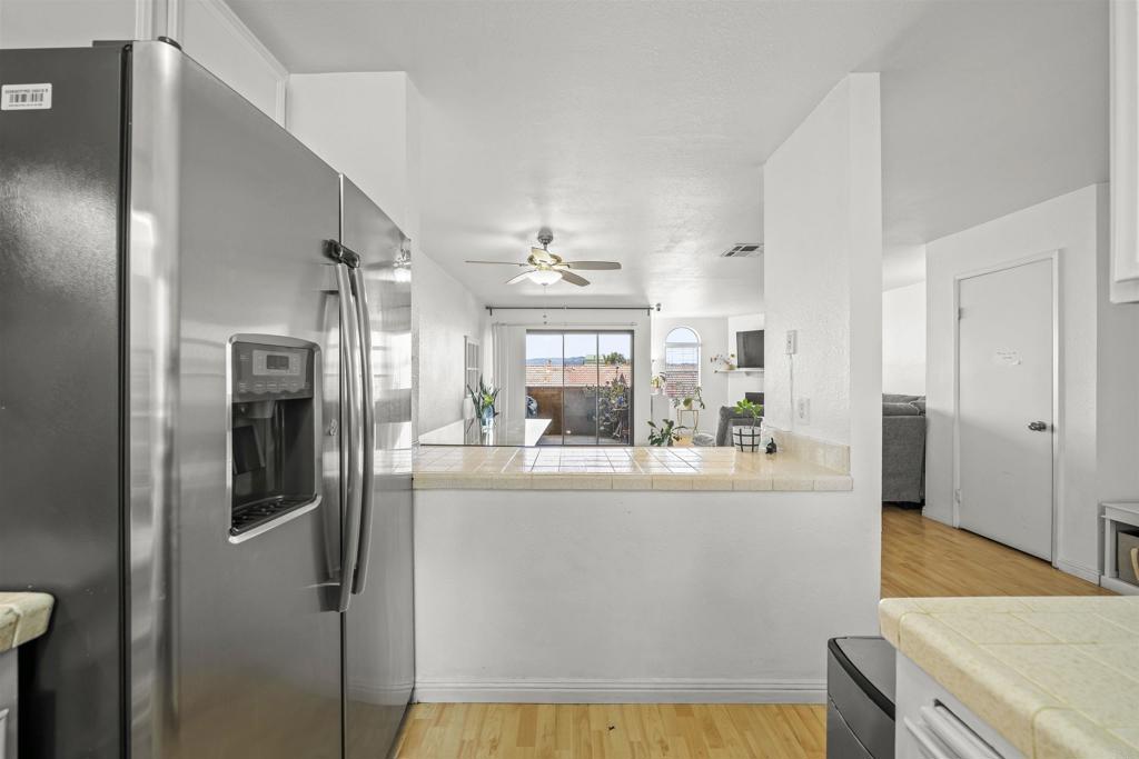 10775 Tamar Terrace, Unit A Santee, CA 92071 - Photo 3 of 38 a view of a kitchen with kitchen island and stainless steel appliances