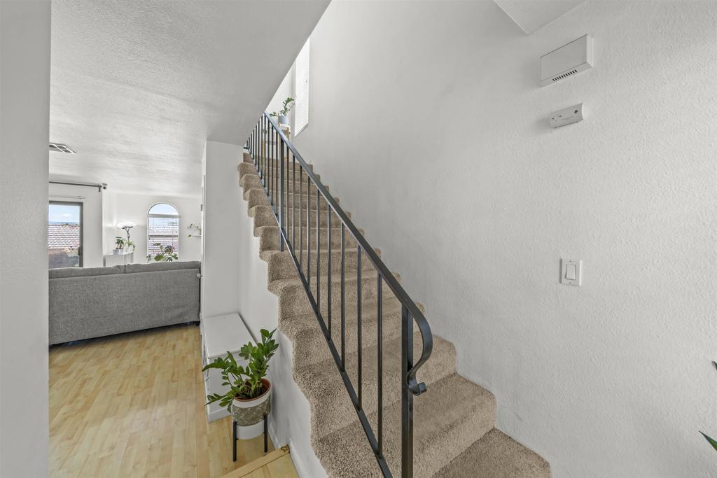 10775 Tamar Terrace, Unit A Santee, CA 92071 - Photo 32 of 38 a view of a hallway with wooden floor and stairs