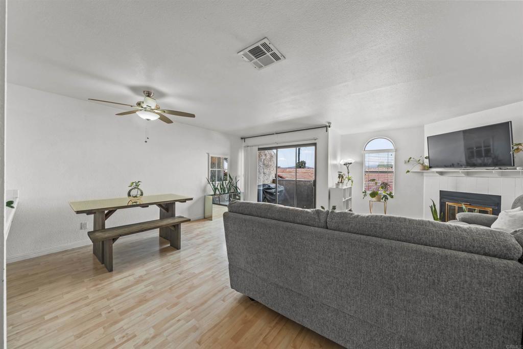 10775 Tamar Terrace, Unit A Santee, CA 92071 - Photo 4 of 38 a living room with furniture and a wooden floor