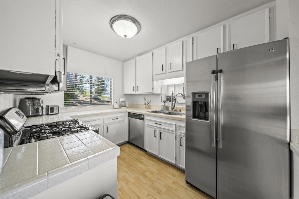 10775 Tamar Terrace, Unit A Santee, CA 92071 - Photo 6 of 38 a kitchen with cabinets and stainless steel appliances